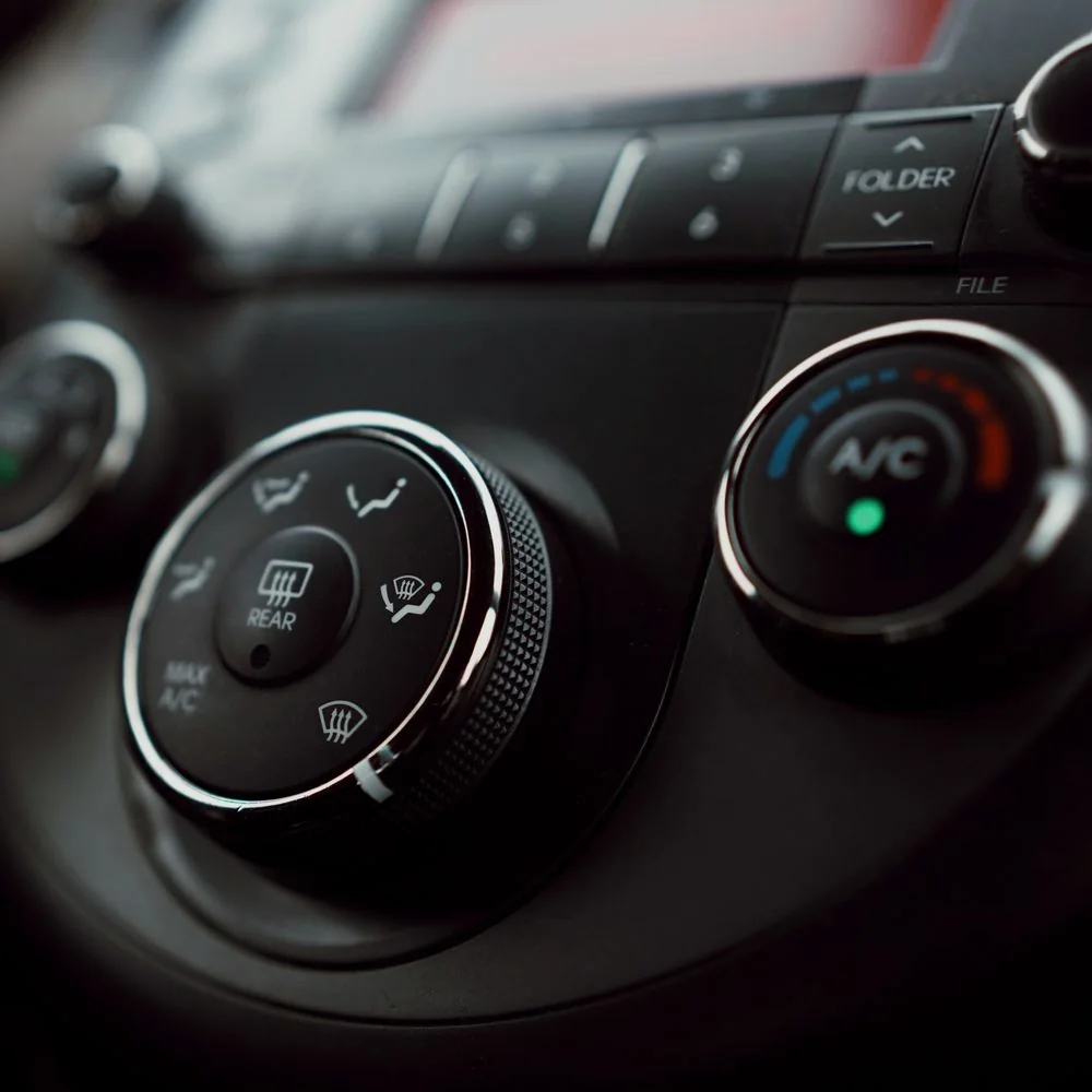 The air conditioning controls on a car's dashboard