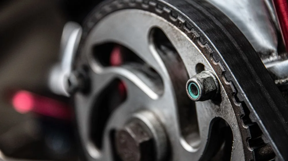 A timing belt running over a camshaft sprocket